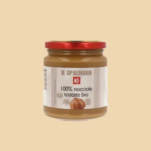 Fronte barattolo: Crema 100% nocciole tostate bio Ki 275g con etichetta frontale “Le Spalmabili” e coperchio rosso.